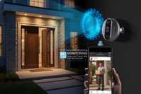 Person wearing a balaclava with a security camera and smartphone displaying monitoring app.